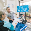 Best St. Dental | Dentist and assistant using advanced microscope for biological dentistry treatment
