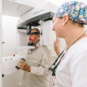 Best St. Dental | Dentist consulting with patient while showing orthodontic scans on monitor